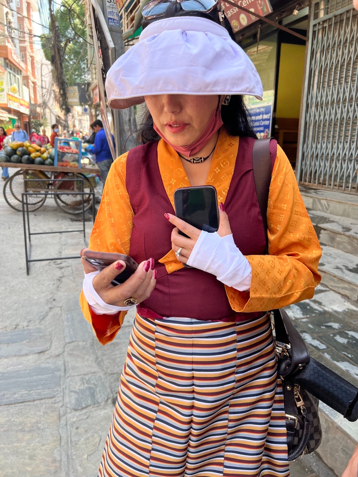 Woman in a white hat on a phone.