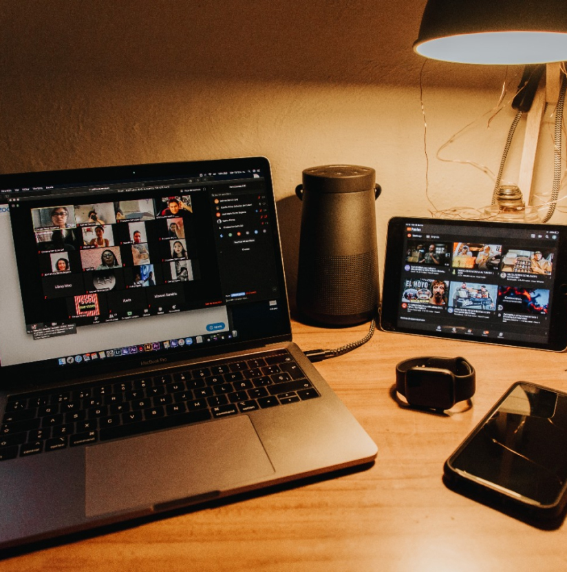 A desk with a laptop. The laptop is displaying a virtual call.